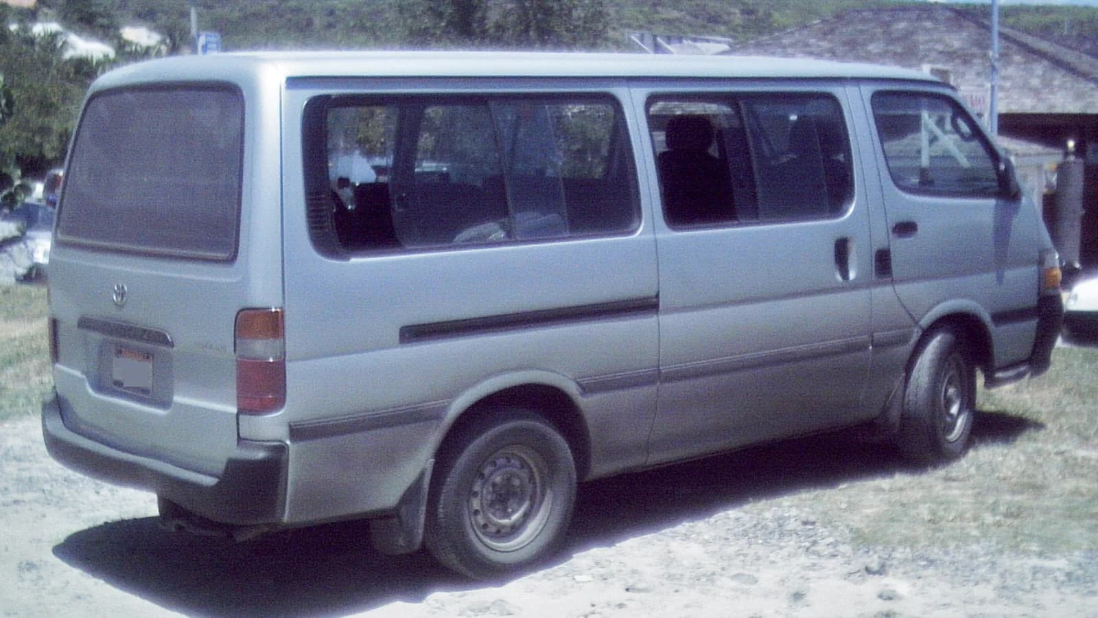 Silver Toyota HiAce viewed from the rear while parked outdoors