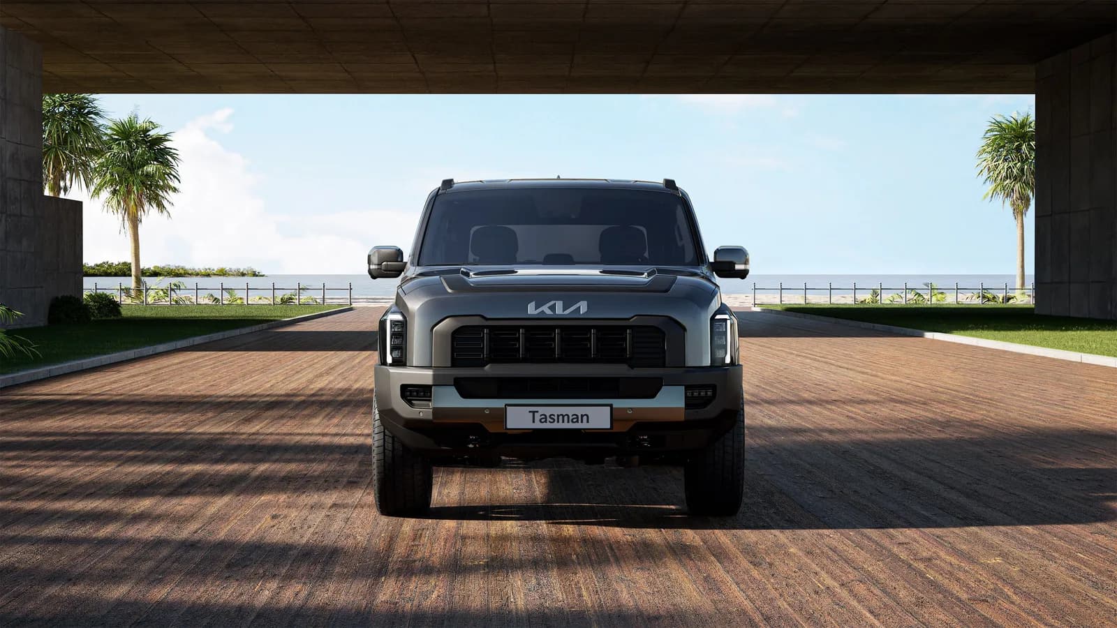 Grey Kia Tasman dual-cab ute viewed head-on under a covered driveway