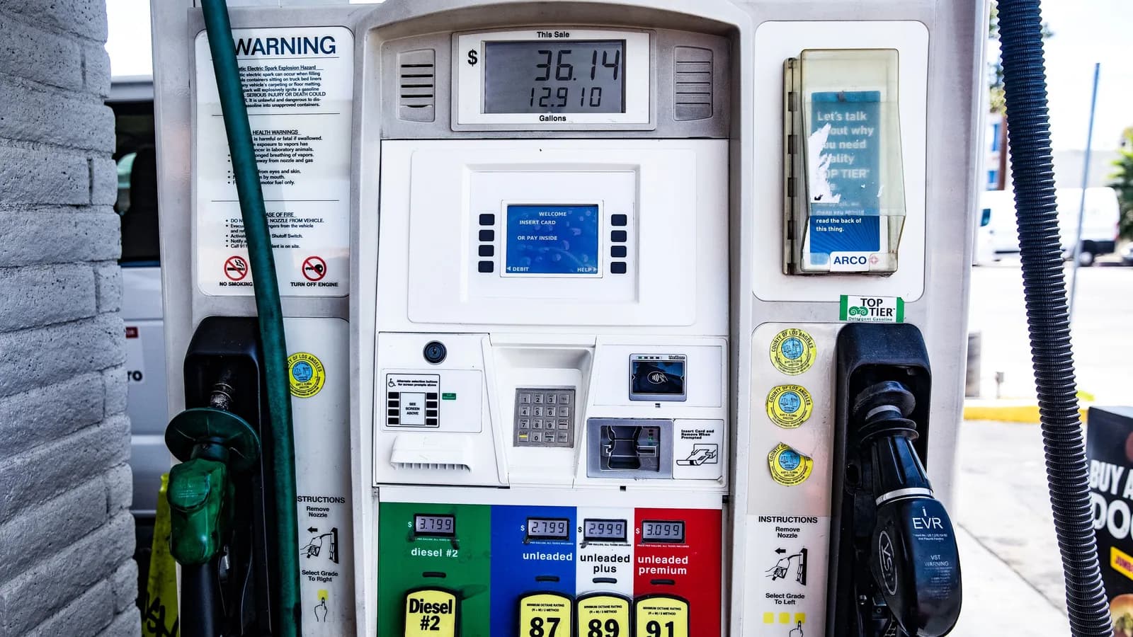 A fuel pump display listing diesel, unleaded and premium grades at a service station