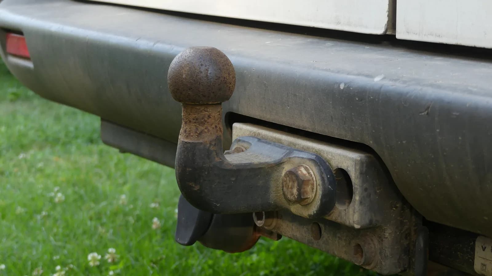 Close-up of a tow ball and hitch fitted to the rear of a vehicle