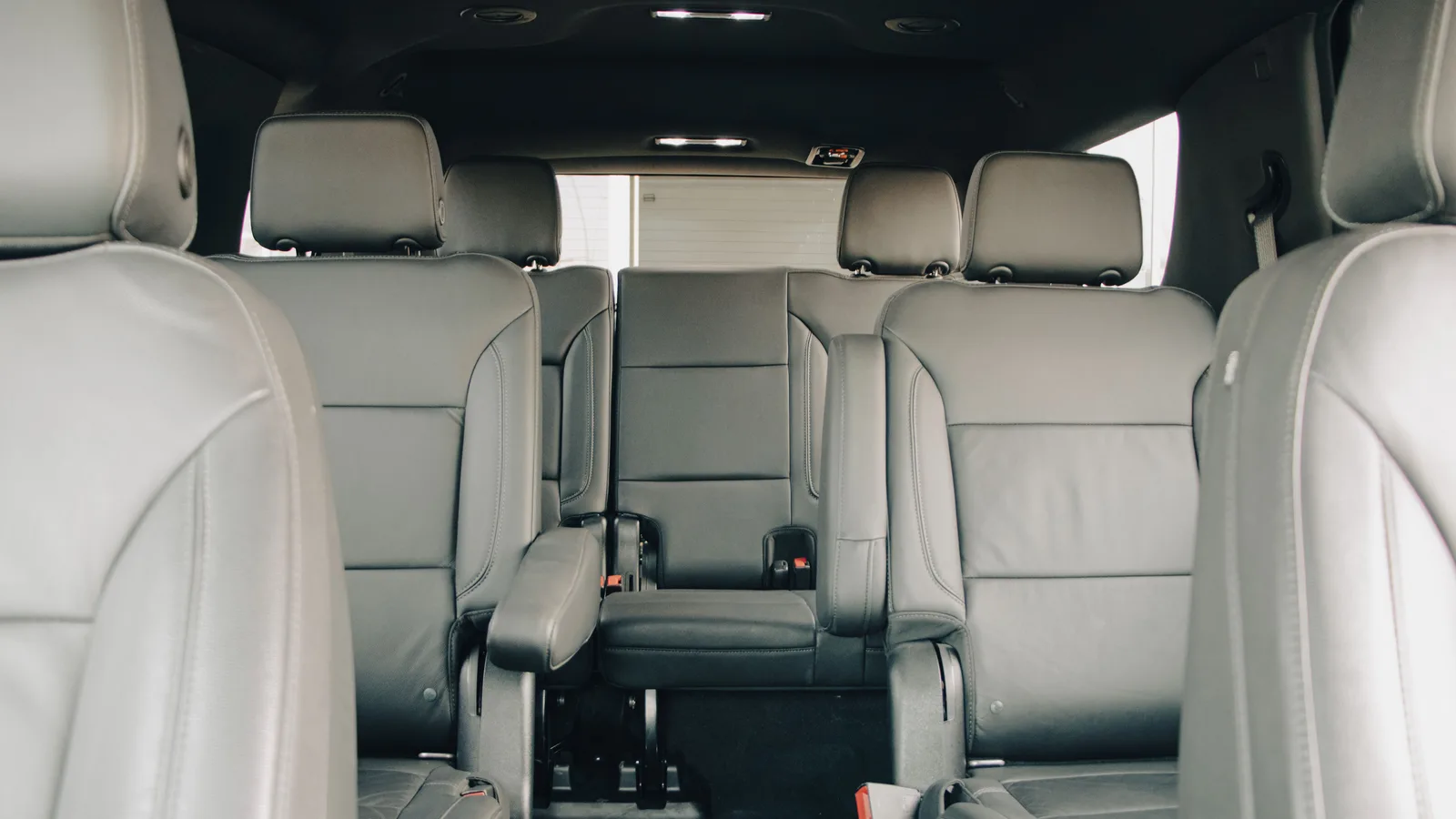 The rearmost seats of an SUV photographed from behind, showing legroom and a folding armrest
