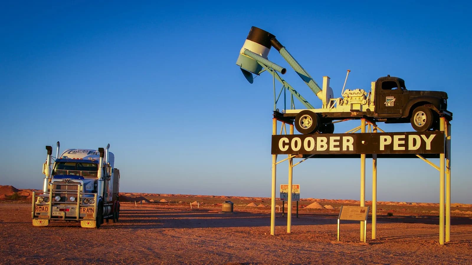 A road train parked beside the Coober Pedy town sign in outback South Australia