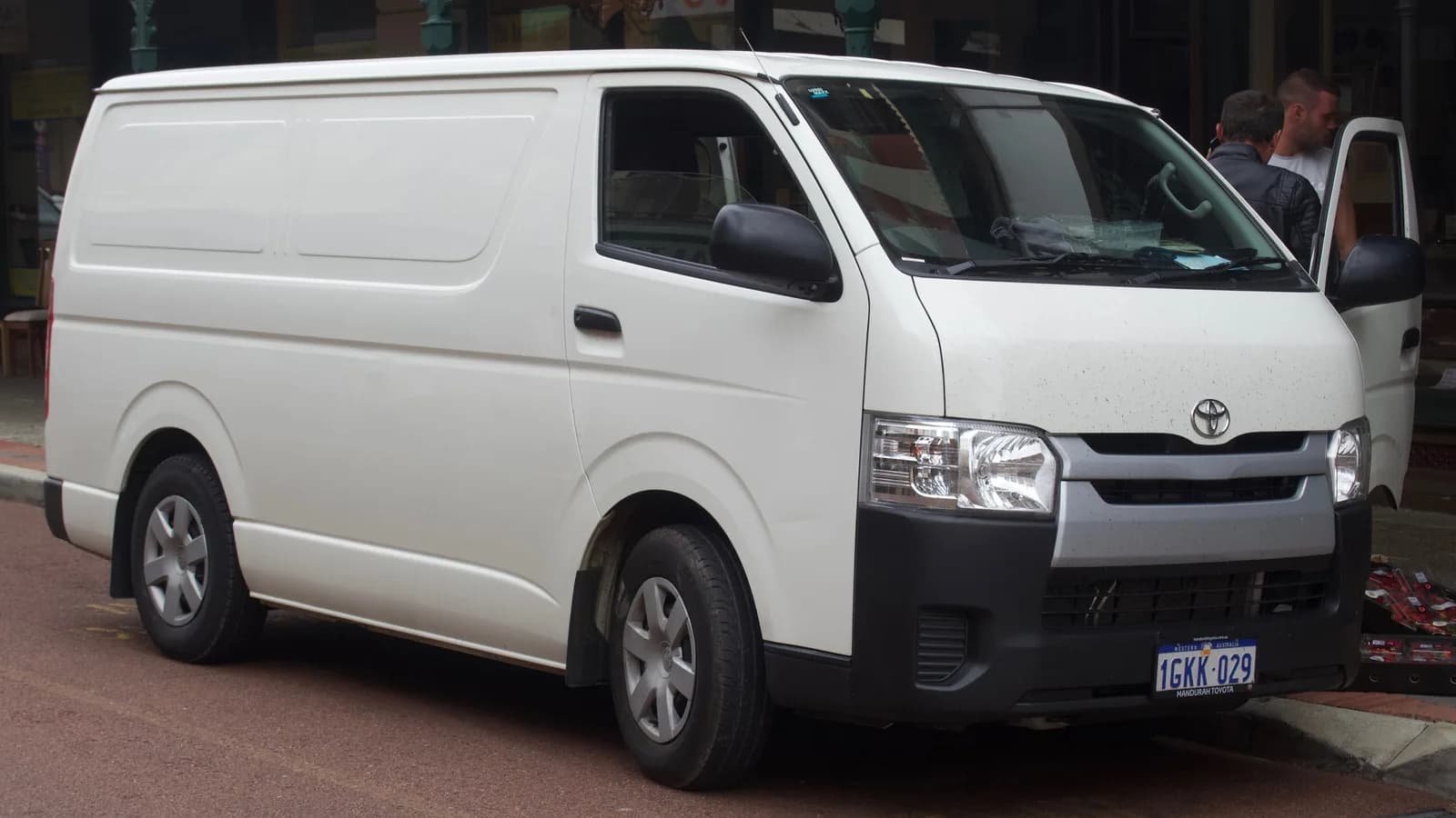 White Toyota HiAce van with Australian number plates parked at the kerb in a town street