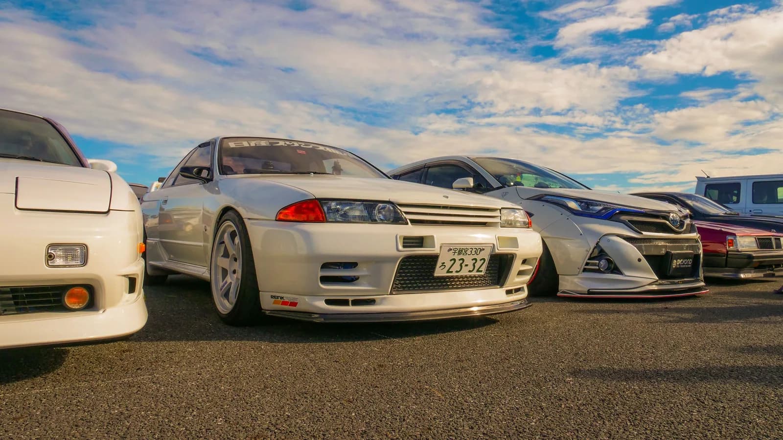 Japanese performance cars parked together in an outdoor display